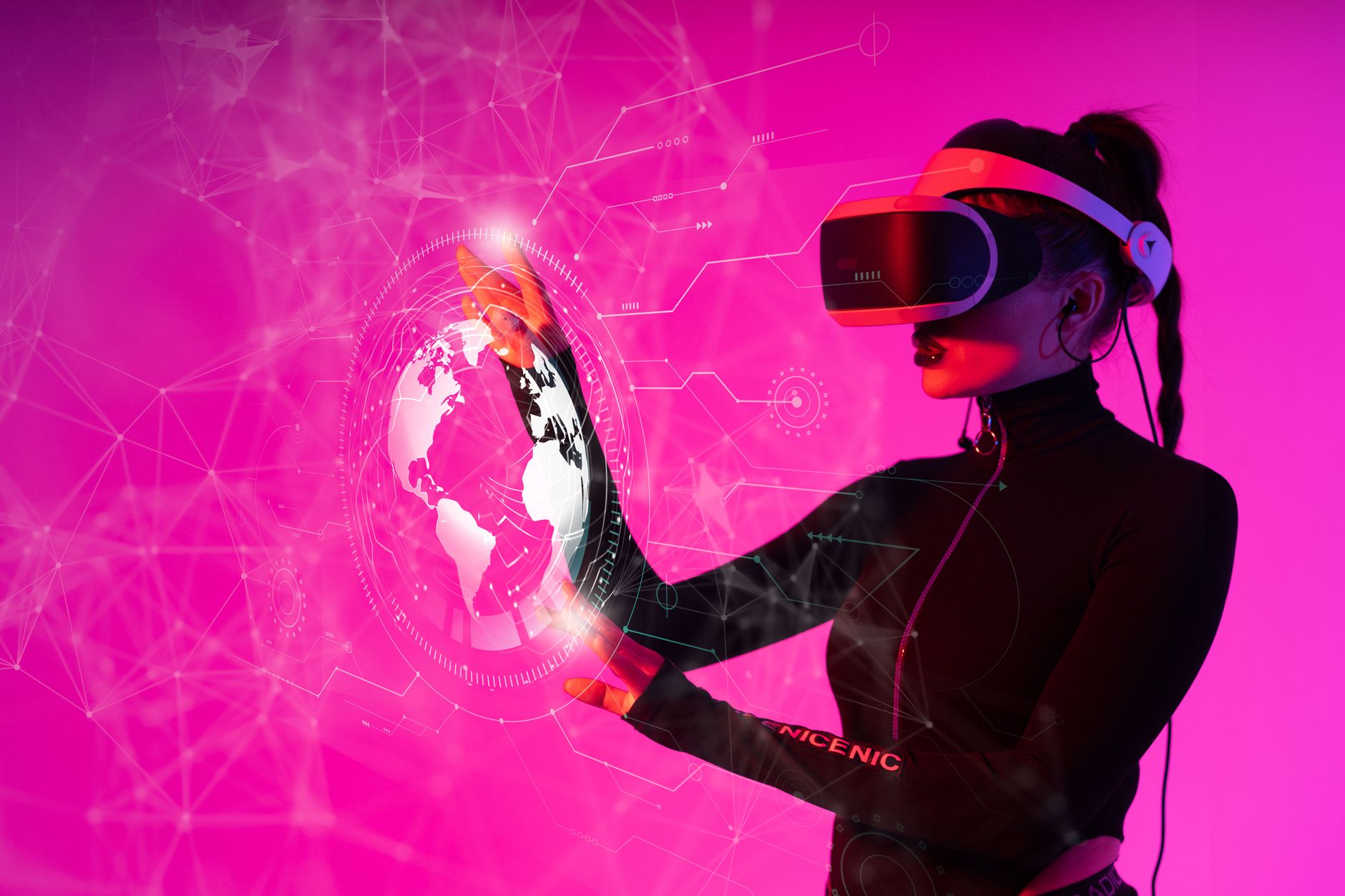 A person interacting with a glowing hologram-style display in a studio
